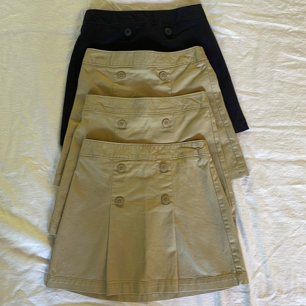 Lot of 4 Old navy girl uniform skirts. 1 navy, 3 khaki- size L 10-12